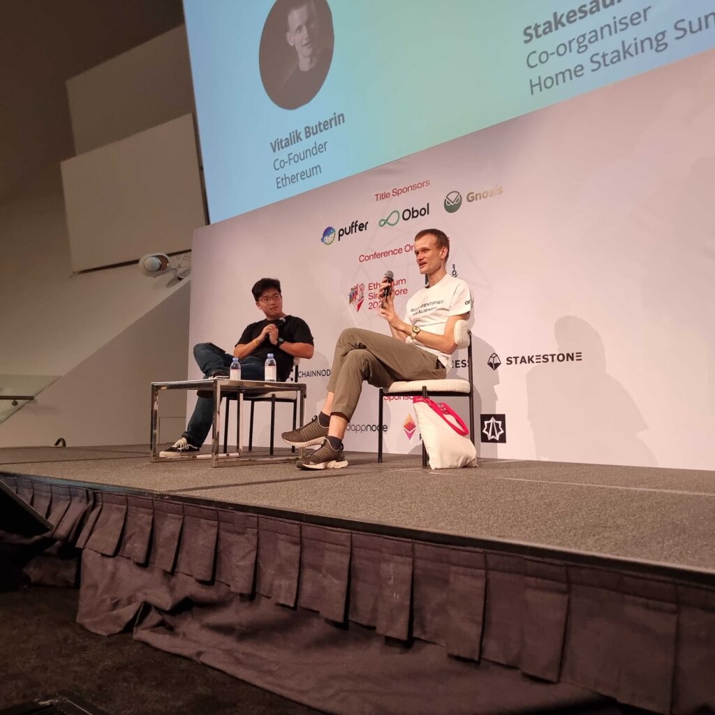 Vitalik Buterin and Samuel Chong discussing network security and the role of staking at Ethereum Singapore 2024.